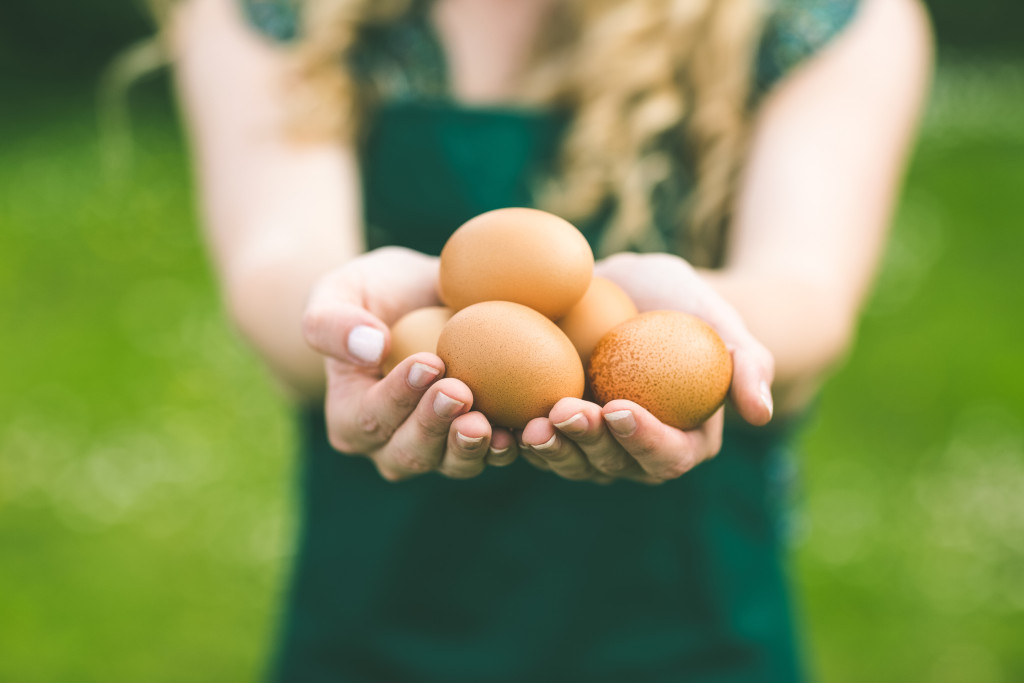 Young woman showing eggs