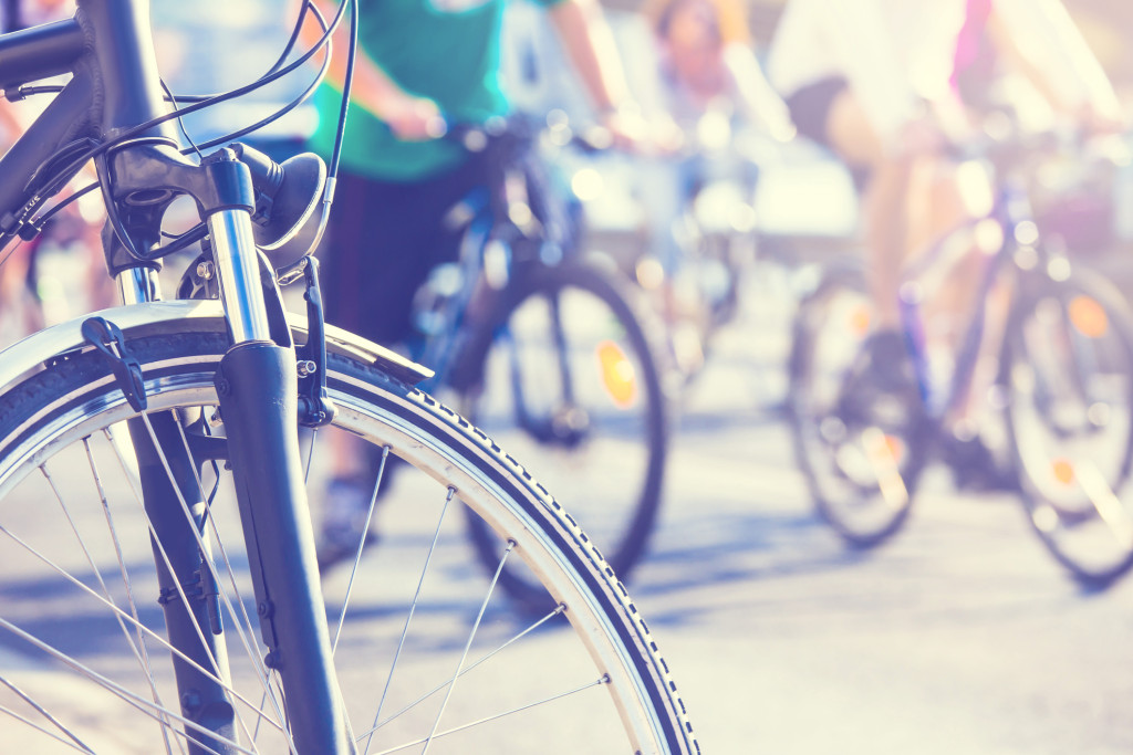 bicycle wheel detail with blurry cyclist