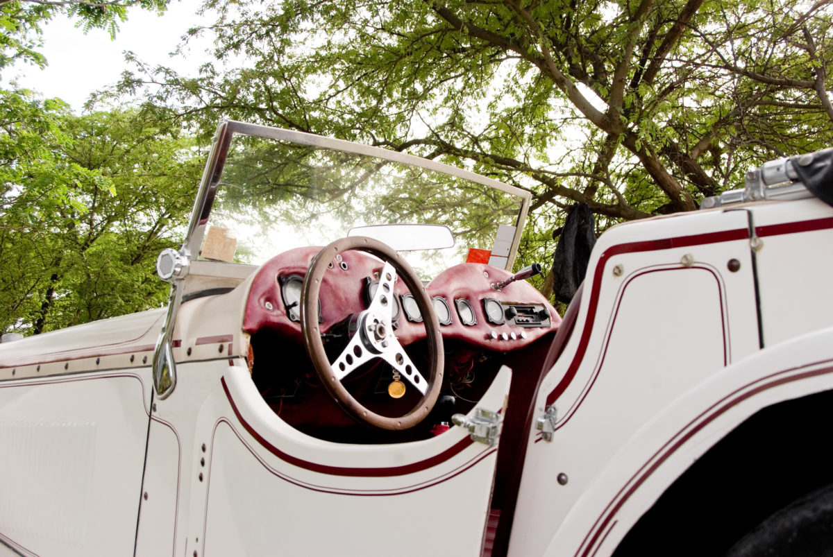 1936 jaguar antique car parked under trees outdoors