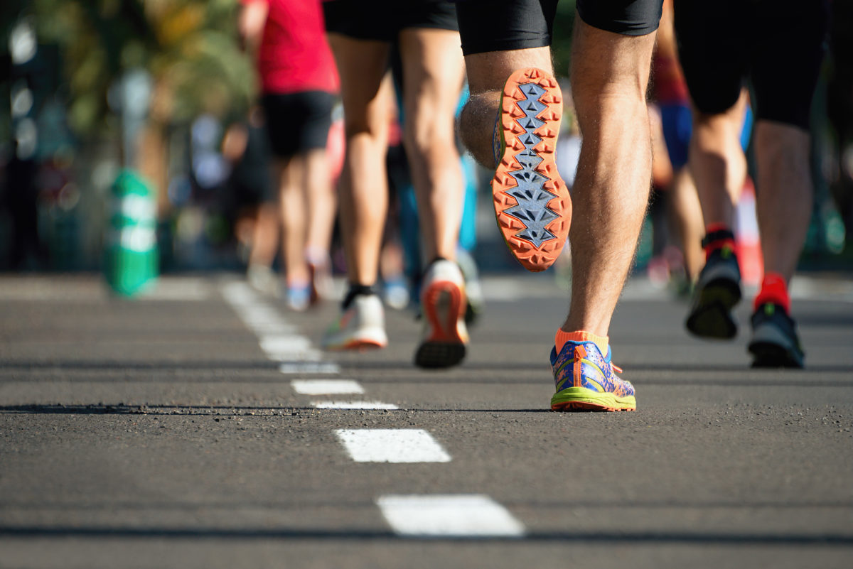 Marathon running race, people feet on city road