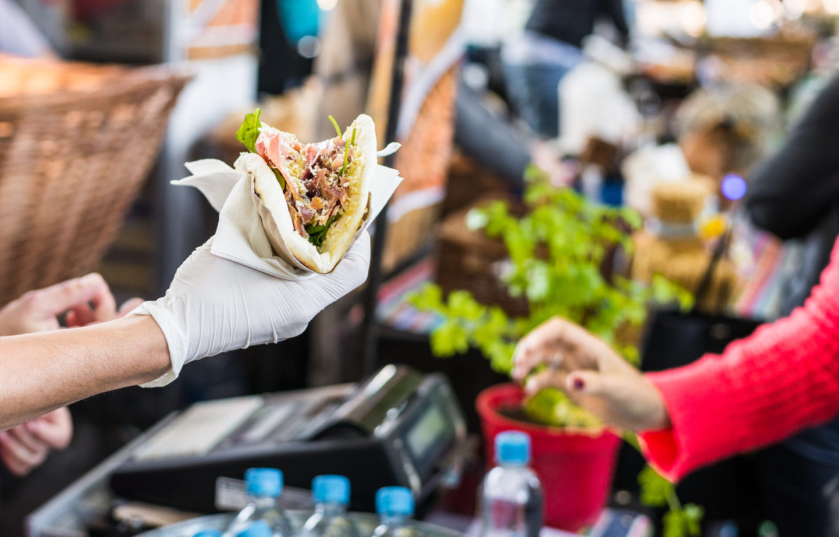 Customer taking their food at a food market