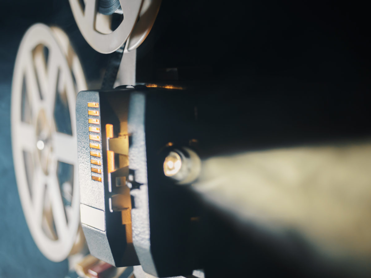 film projector on a black background with dramatic lighting and selective focus