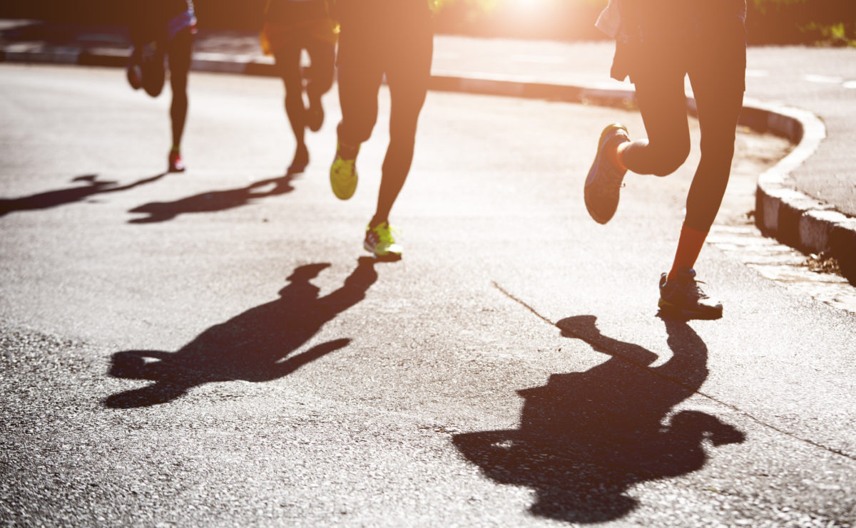 Shadows of runners on the road