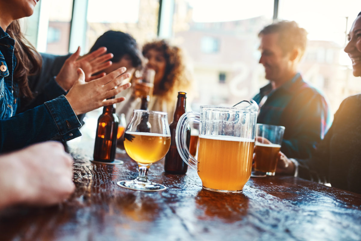 Cropped shot of a jug of beer on a counter at a bar